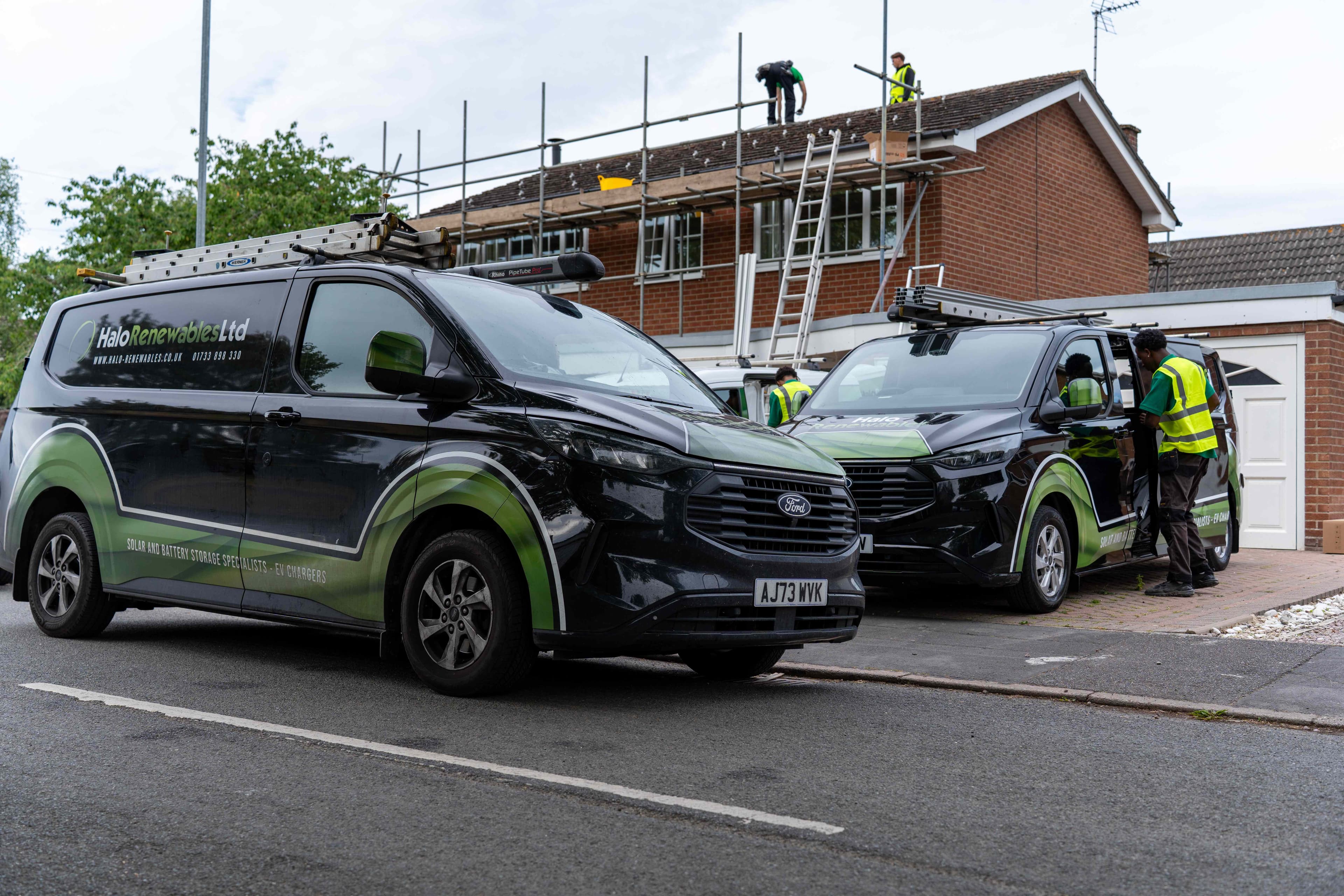 Halo Renewables installation with branded vans and rooftop solar work
